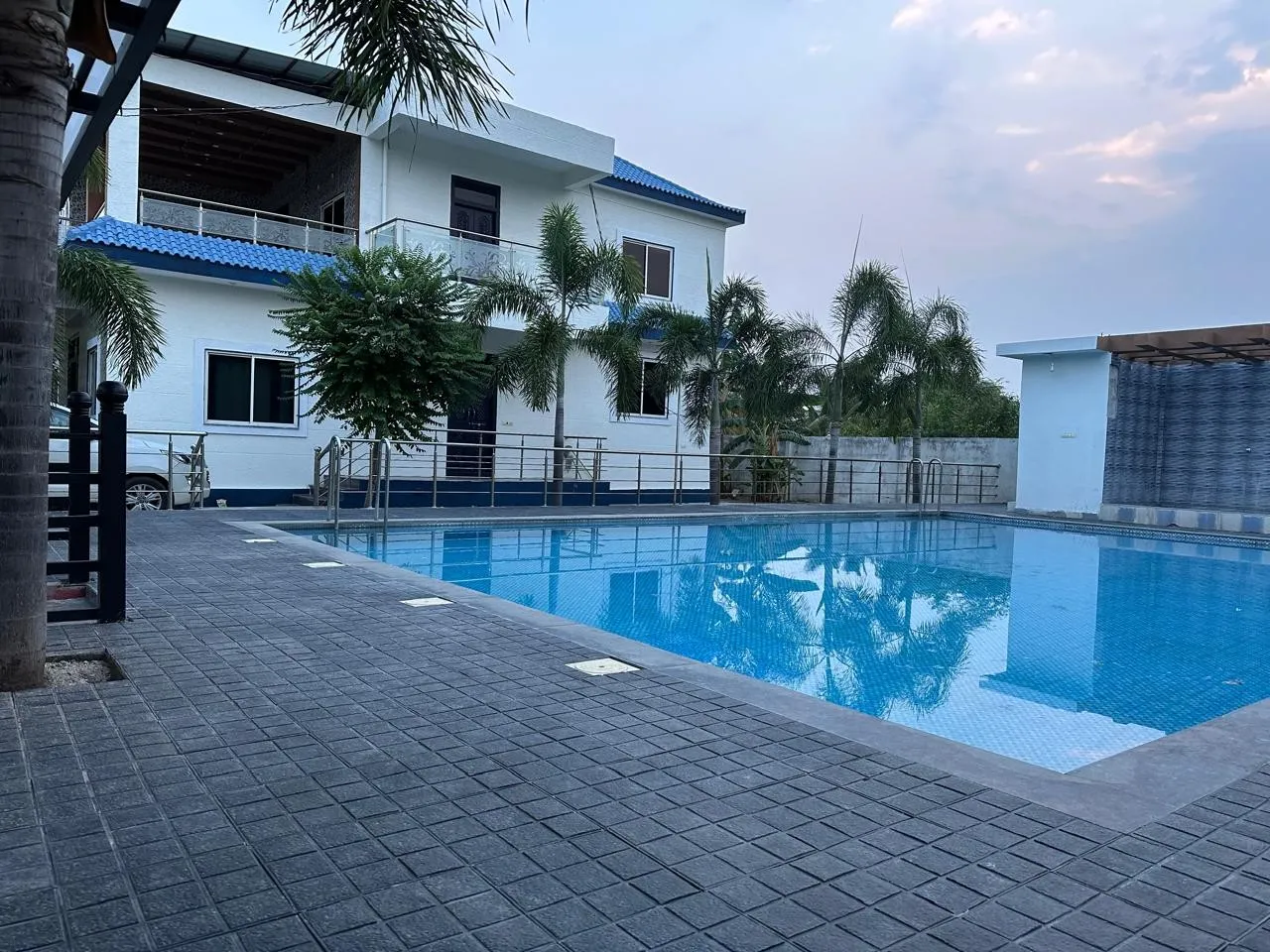 Private swimming pool at The Orchids FarmHouse, Moinabad